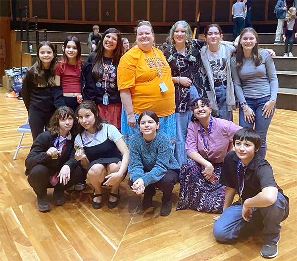 Forensics Team inside the Drum at the school. 10 students and two teachers in this group photo.