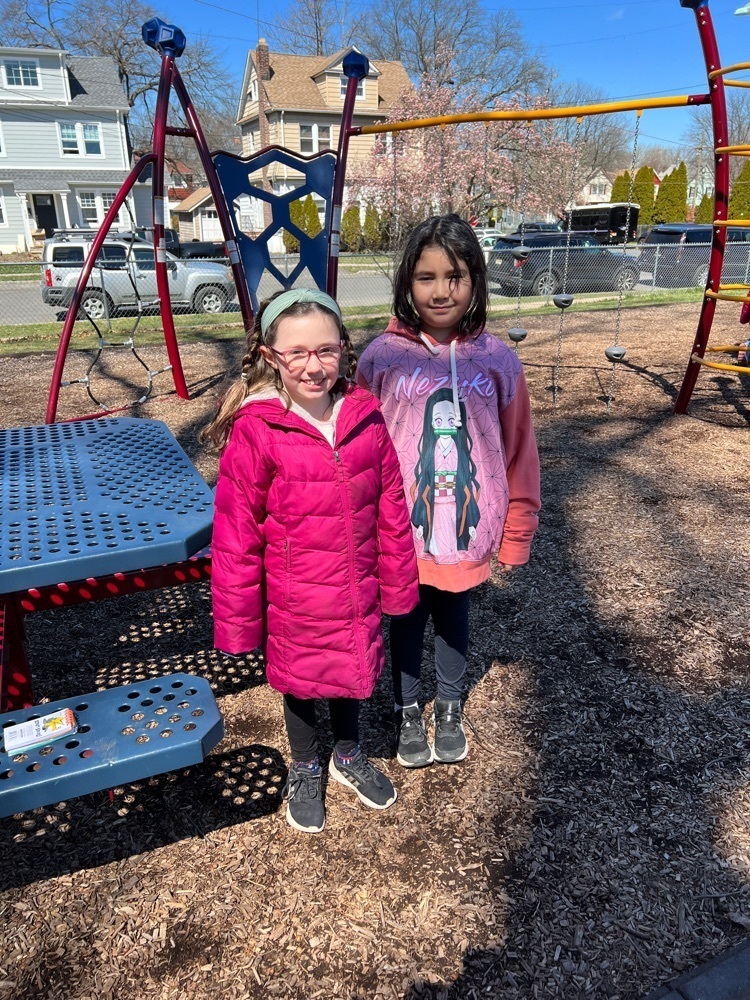 two girls pose for a photo at recess