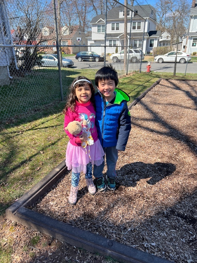 two first graders at recess standing outside on the playground