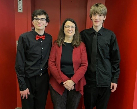 students posing outside an elevator
