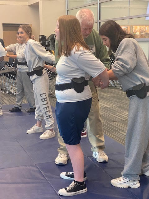 Emily and Divanelli get some pointers from Mr. Ruffin.