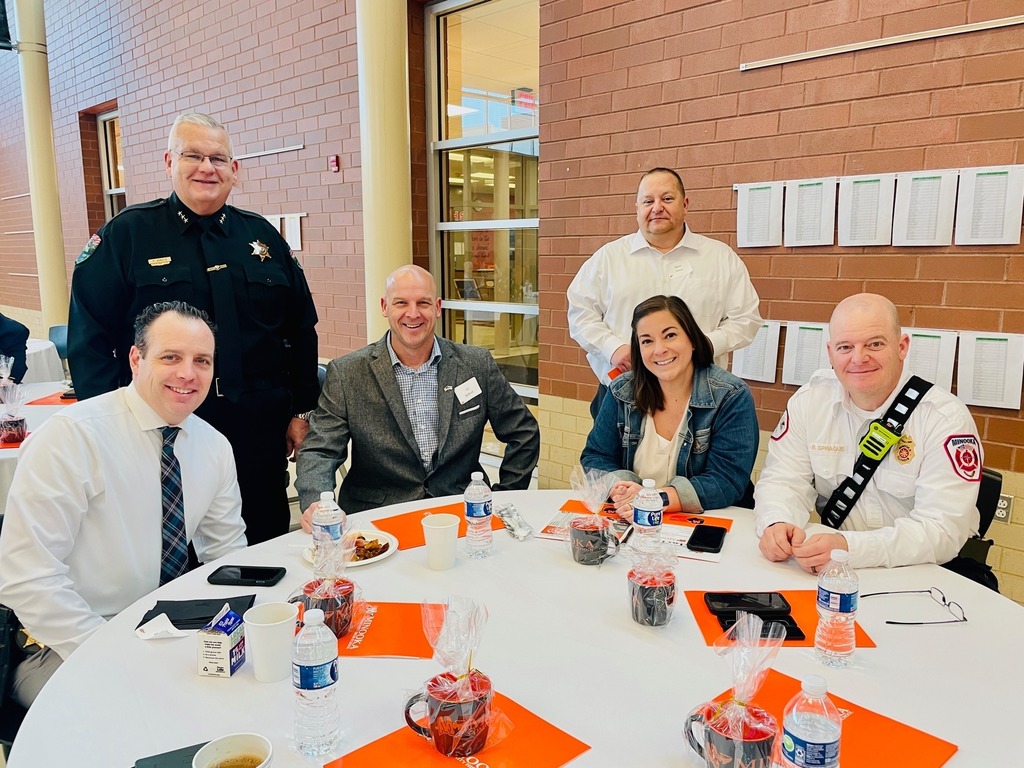 group of people from the community sitting at banquet table and smiling