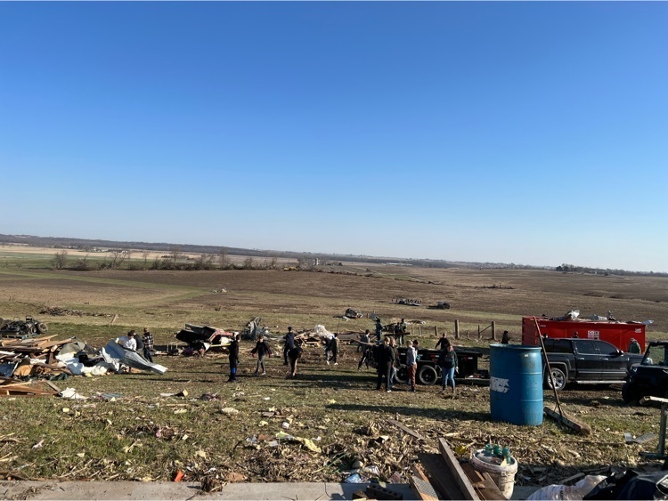 students cleaning up tornado debris