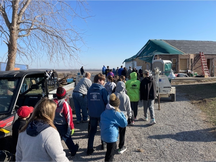 students cleaning up tornado debris