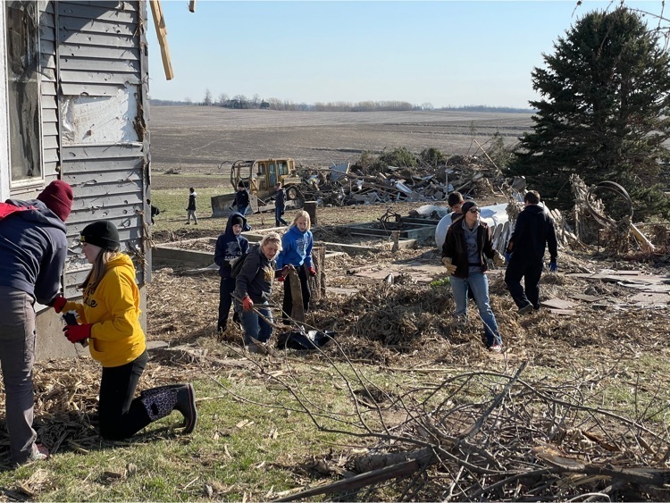 students cleaning up tornado debris