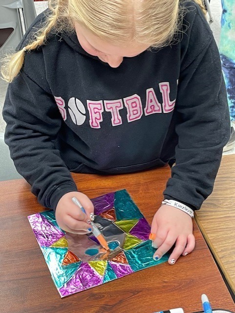 student working on art