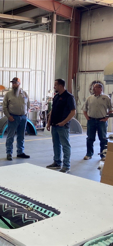 Tyler, Dustin, and Balta explaining how they refinish older trucks