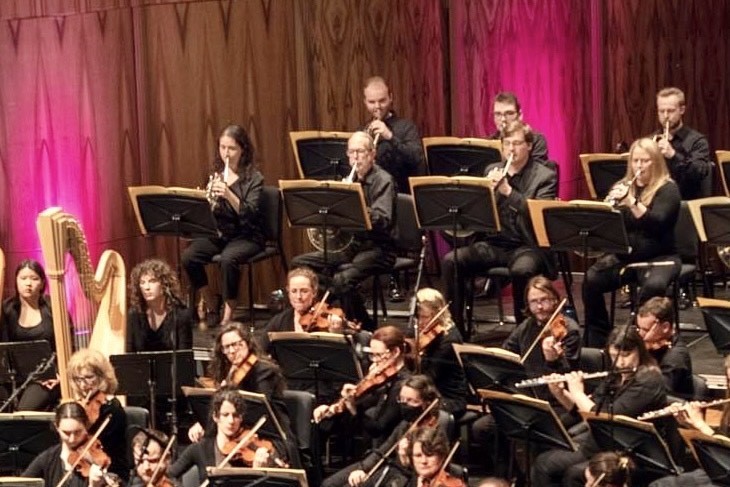 Akron Symphony photo with a teacher and an alumnus