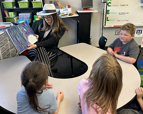 prom queen candidate reading to Blackmore students