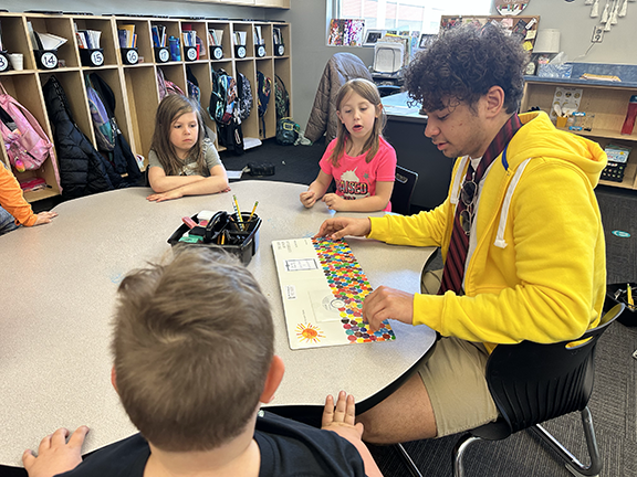 prom king candidate reading to Blackmore students
