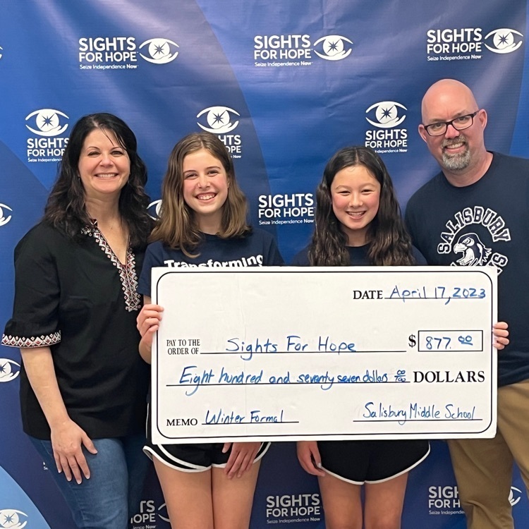 Interact members presenting a check to Sights for Hope
