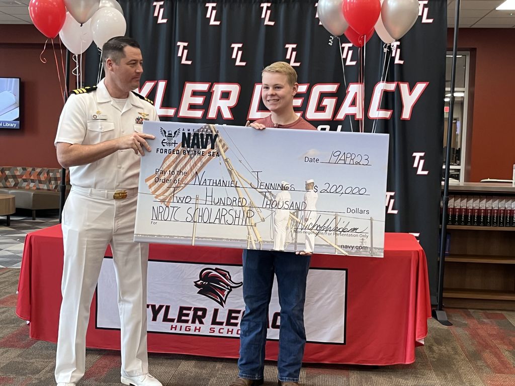 Legacy student Nate Jennings with his scholarship check