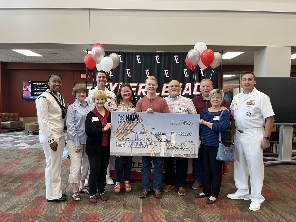 Legacy student Nate Jennings with family and Navy with his scholarship check