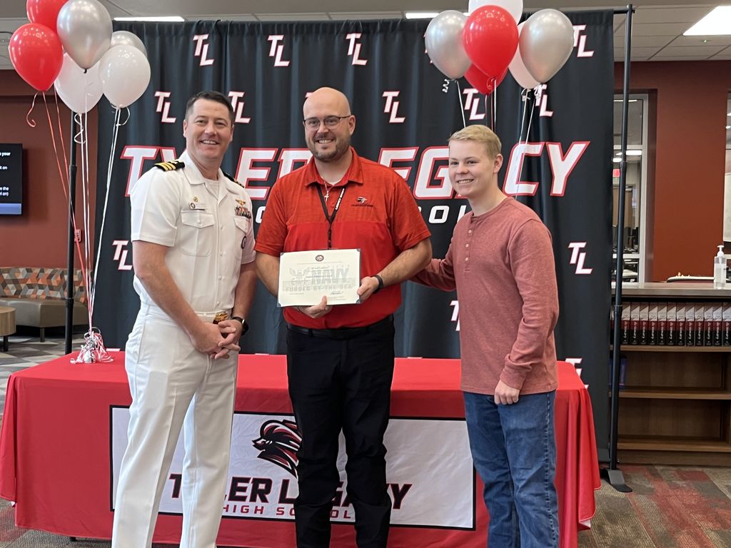 Legacy student Nate Jennings and band director Sam Labordus with his recognition 