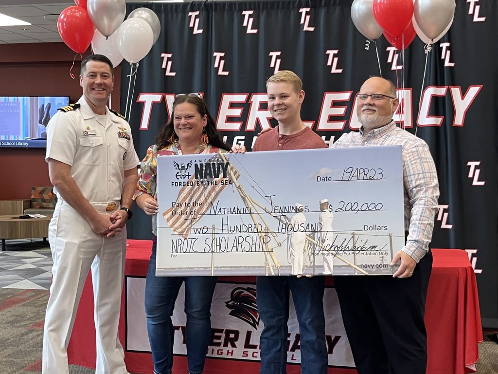 Legacy student Nate Jennings with his parents and his scholarship check