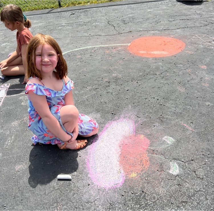student with sidewalk chalk