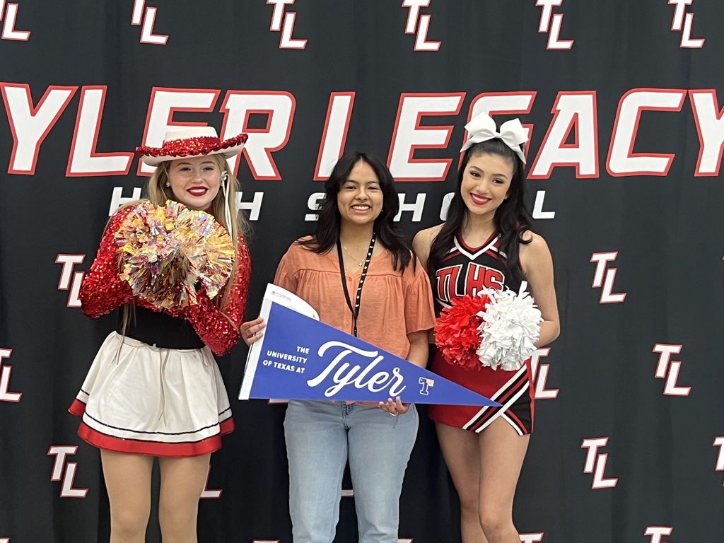 Legacy senior Namarie Perez holiding a UTTyler pennant at Decision Day