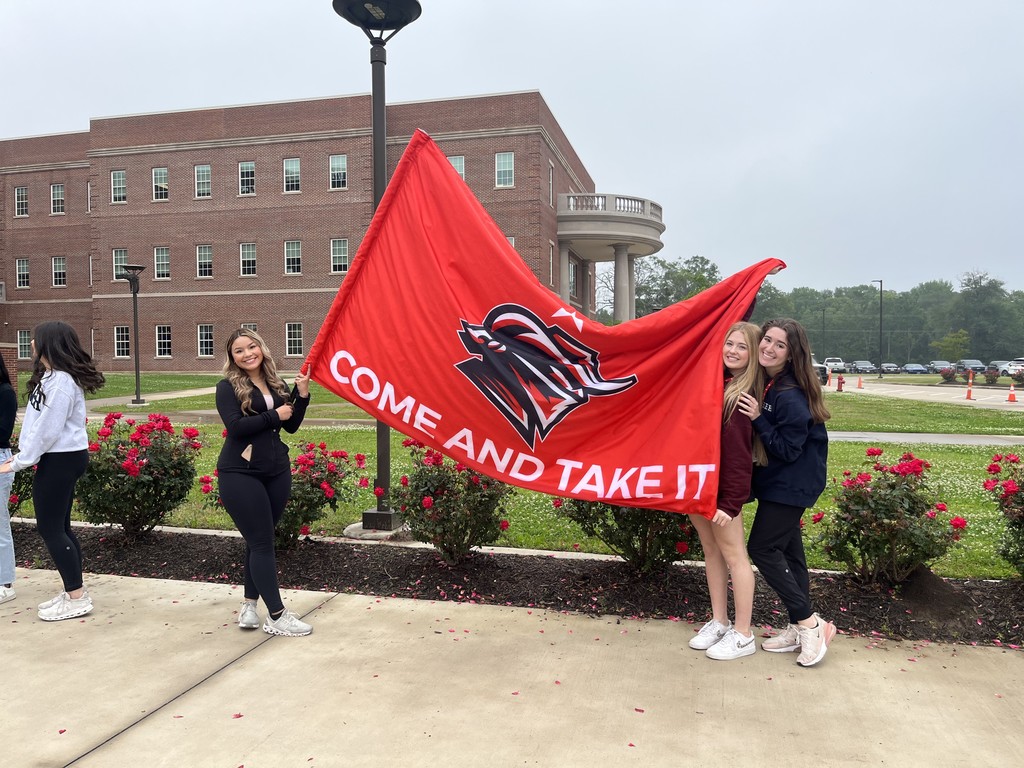 Legacy Southern Belle Drill Team with Raider flag at UIL send off to regionals