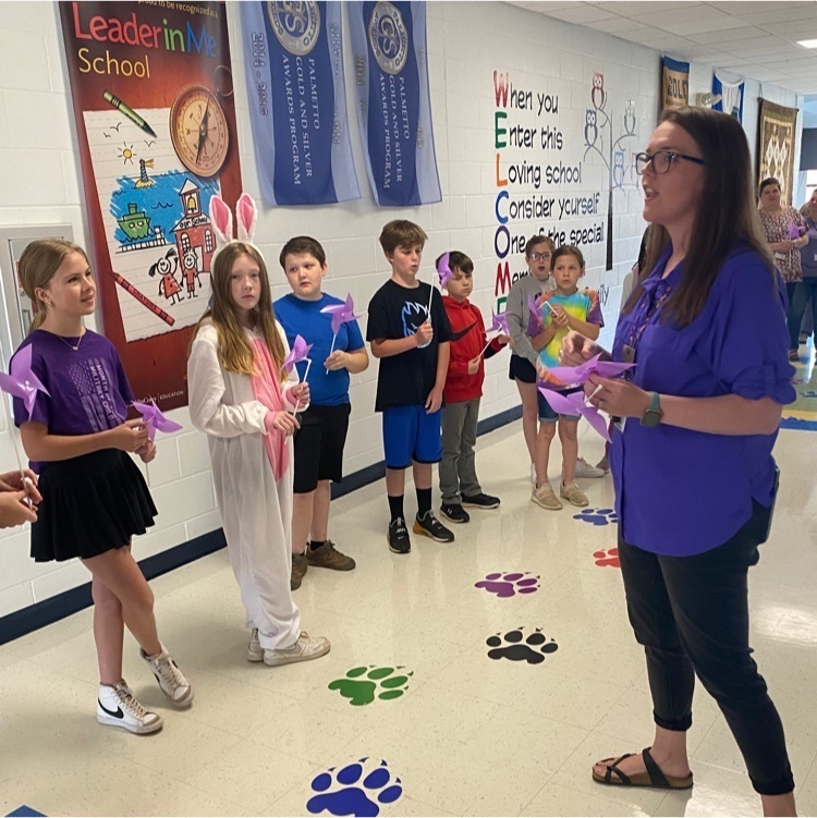 students putting pinwheels down