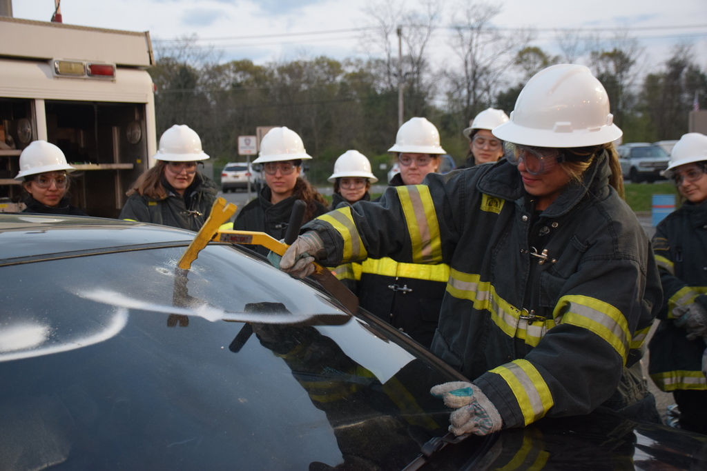 Locust Valley High School senior Angelina Navas punctured the window of a car as part of a mock car crash rescue.
