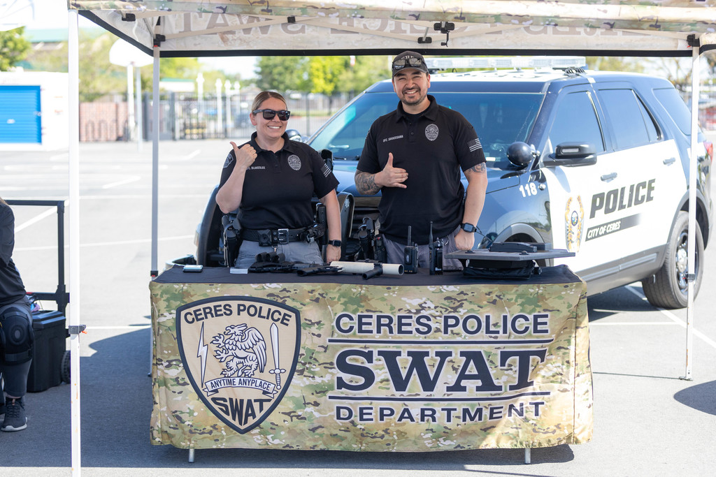 Two smiling officers at Ceres Police table