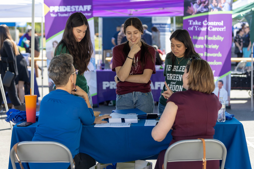 Three female job seekers visit CUSD table