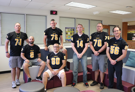High school staff participate in homecoming twin/group day dressed as football players