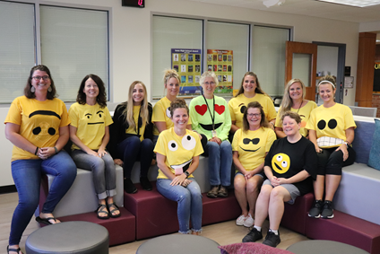 High school staff participate in homecoming twin/group day dressed as emojis