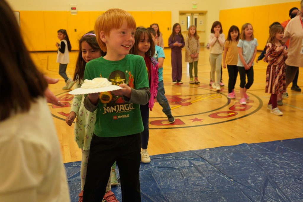 Excited child about to throw a pie