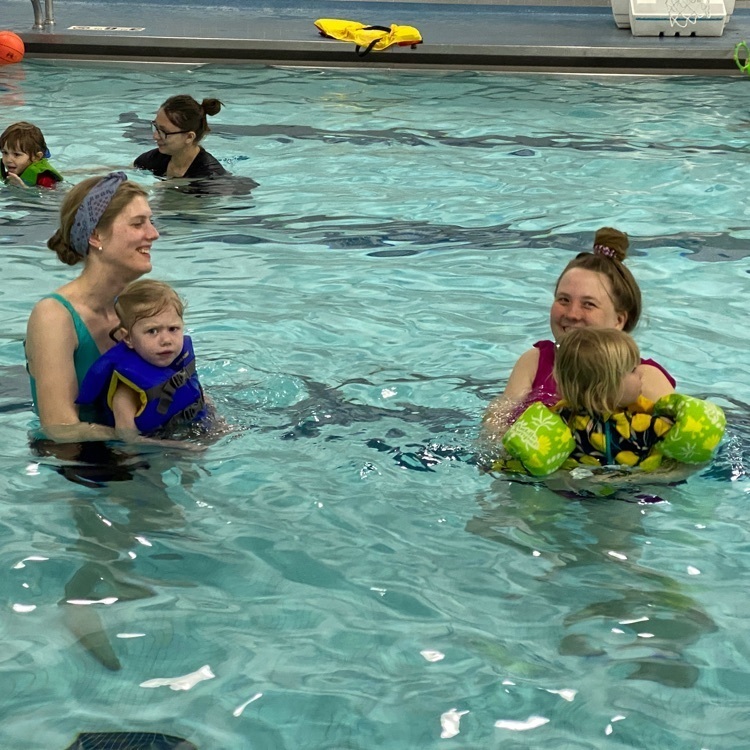 moms swimming with their daughters  