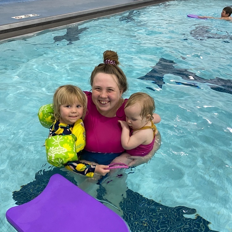 mom swimming with two daughters  