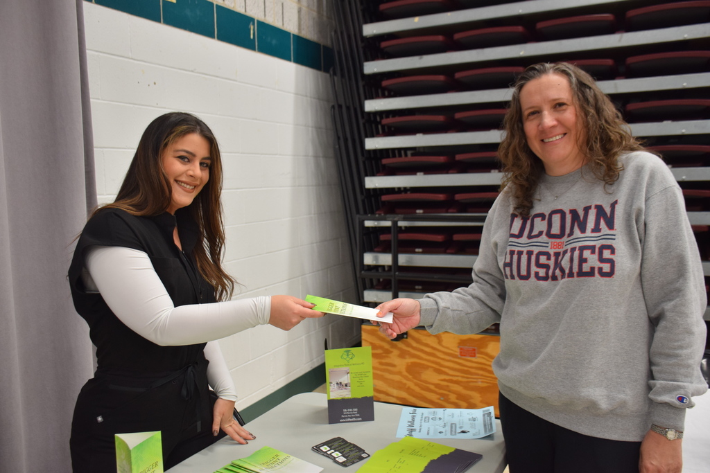 Staff member Ivanka Serio talks with a representative from Integrative Medical Wellness.