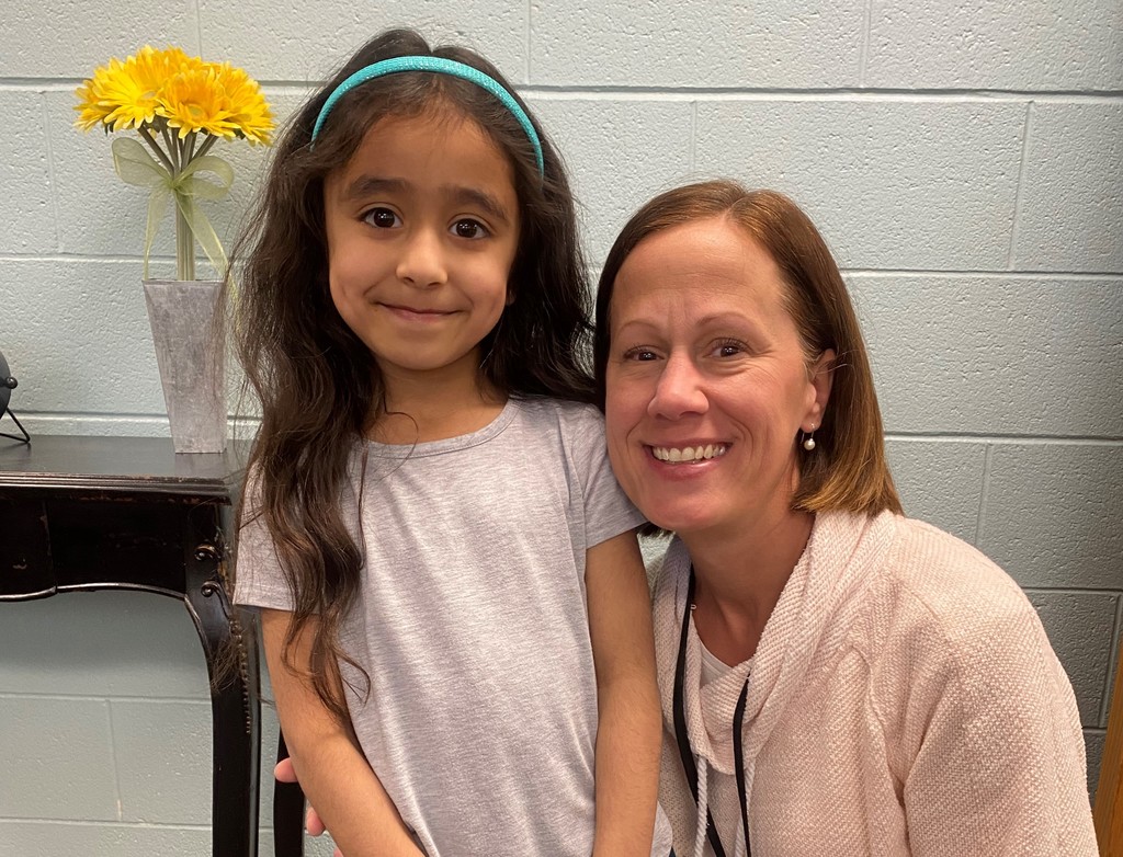 Child with her teacher
