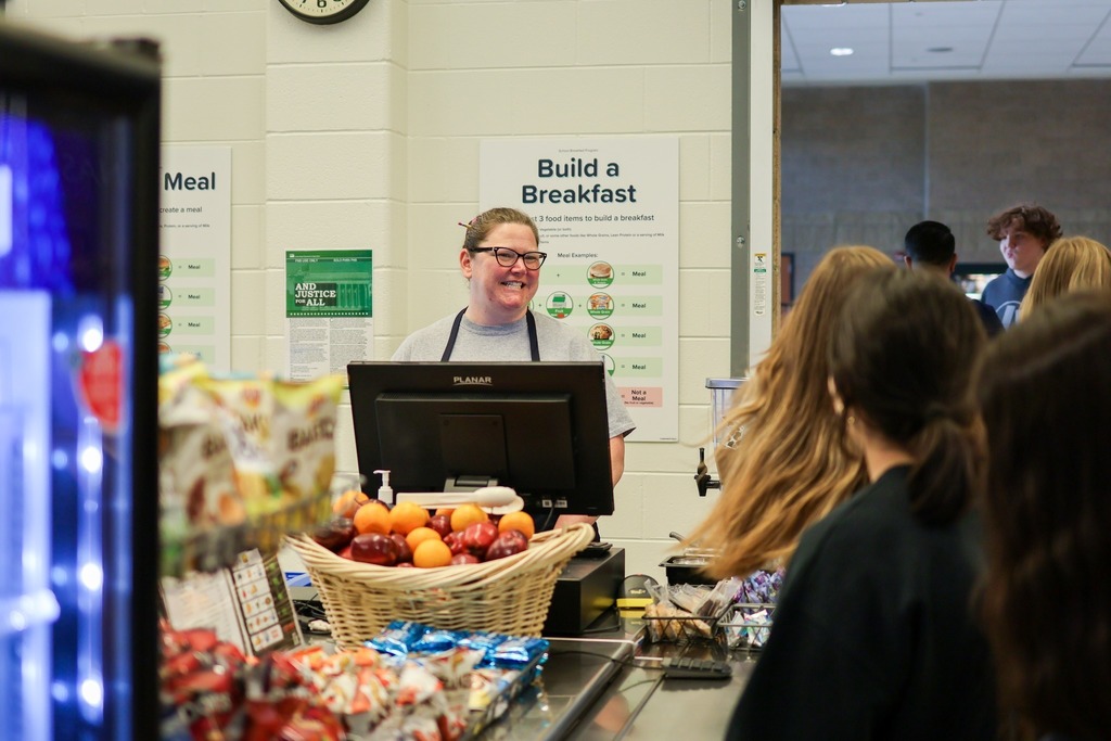 Food service worker helps students