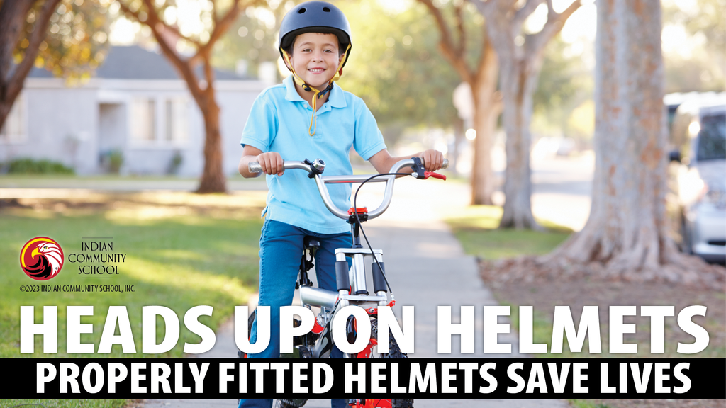 boy wearing a helmet, riding a bike on the sidewalk; heads up on helmets and bike safety