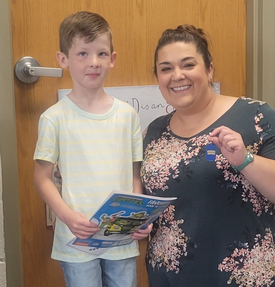 Teacher with student receiving award
