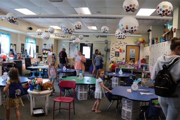 picture of students and families touring a classroom 