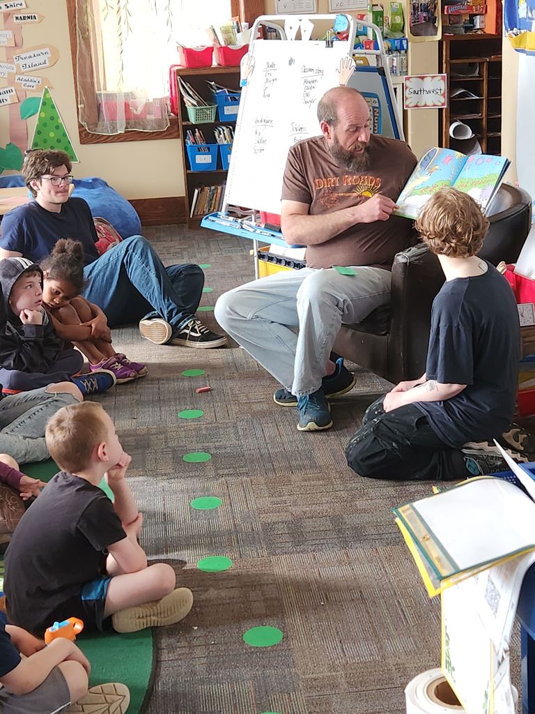 MNCS High School Advisor Jim Wartman reading "The Lorax" to students.