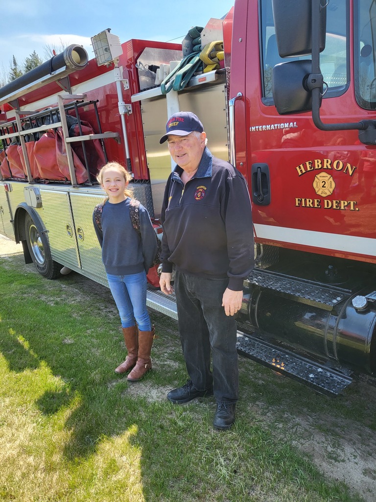 A 5th grader getting a fire truck ride home