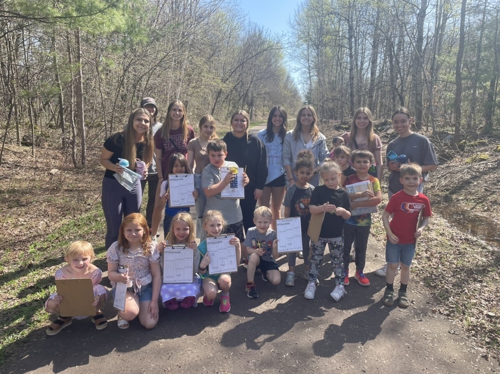 High school students with kindergarteners outside