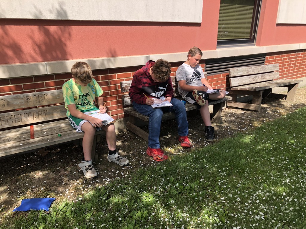 Boys doing homework on benches