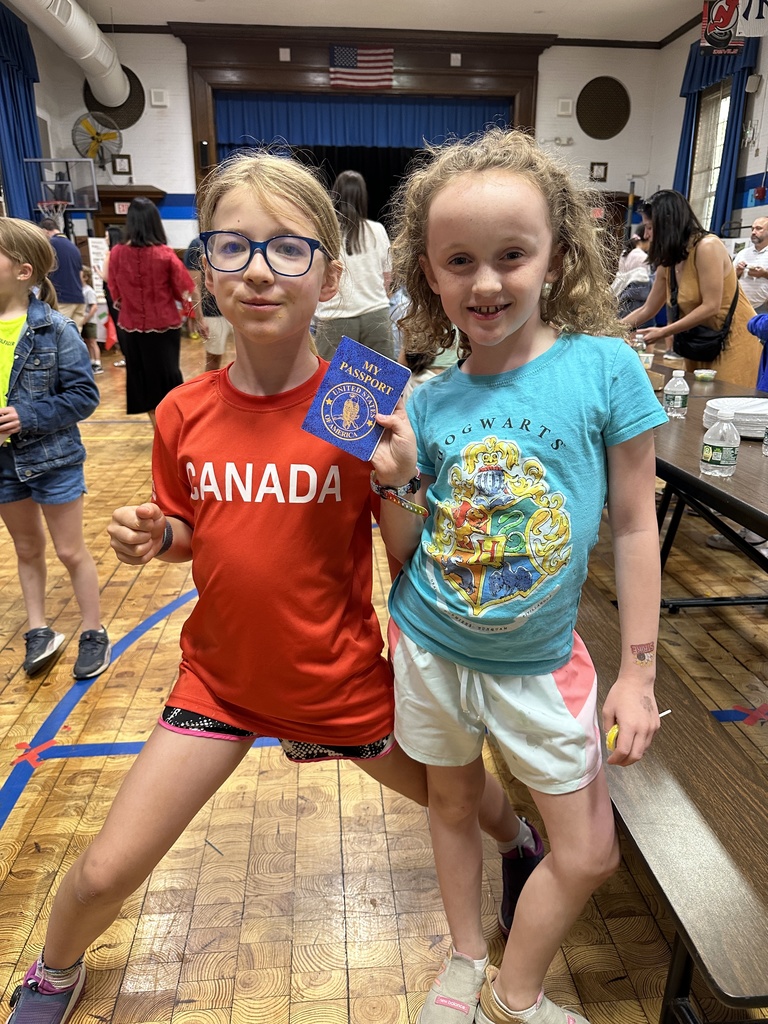 Two third grade students with a passport during the Multicultural Festival