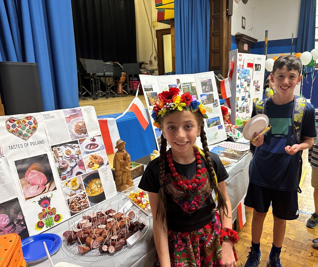 two students standing near the display for Poland