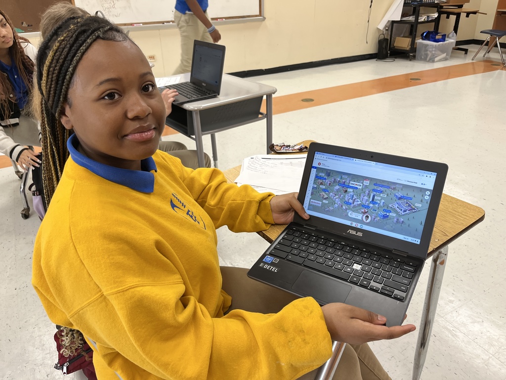 A student shows the simulation on her Chromebook screen.