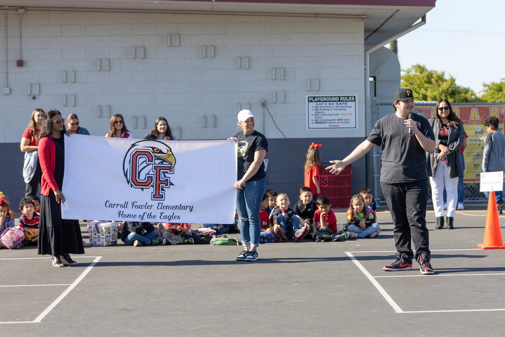 School assembly displaying new logo