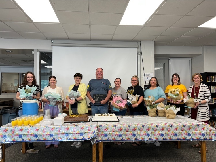 Staff members with going away gifts 