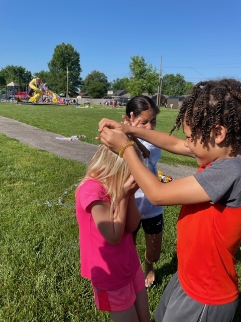 students playing in water