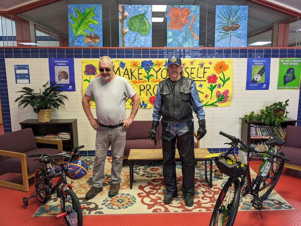 Two members of the Masons delivering bikes to PES.