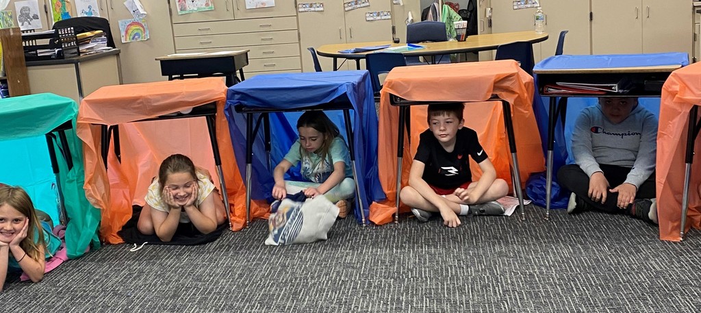 Students work under their desks