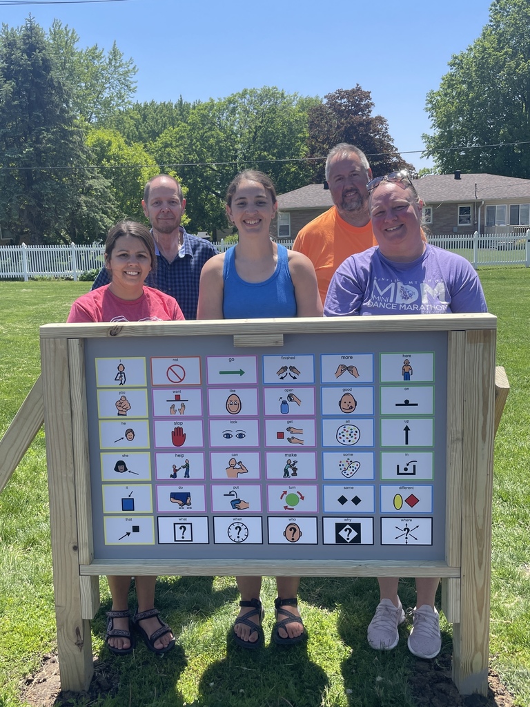 Employees posing with the playground core board